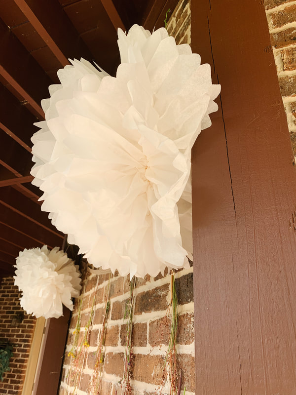 tissue pom pom attached to wood post
