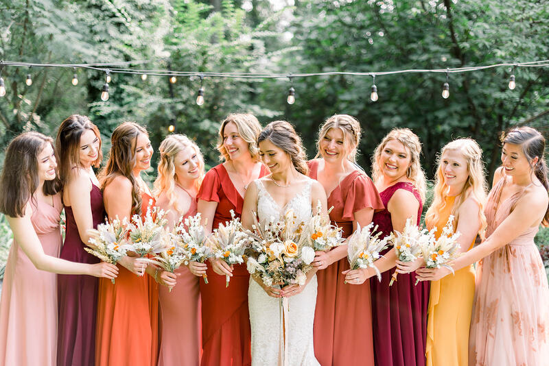 boho bride with bridesmaids in mismatched earth-tone dresses