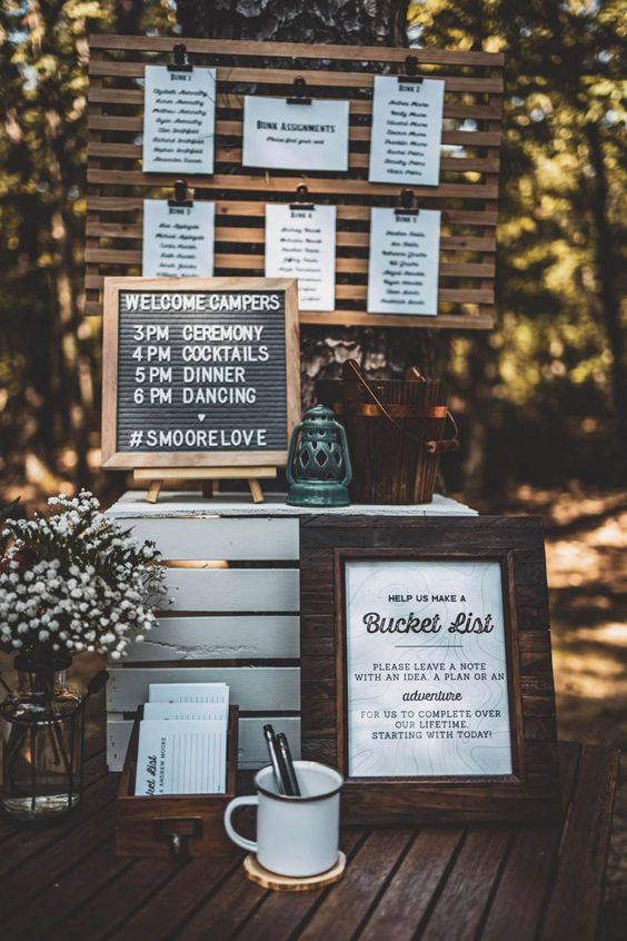 bucket list guest book decorated with signs and white florals