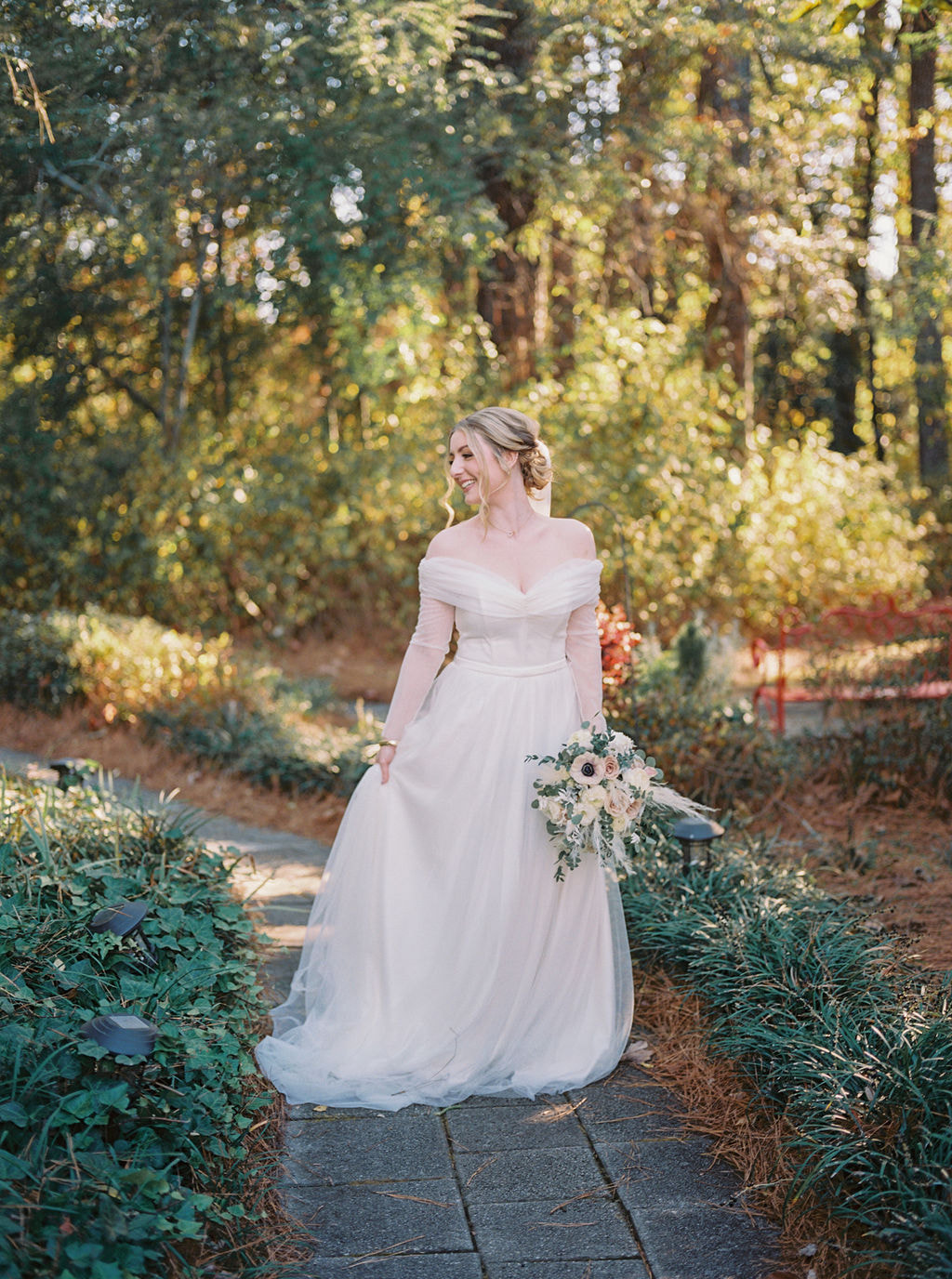 bride posing along garden path