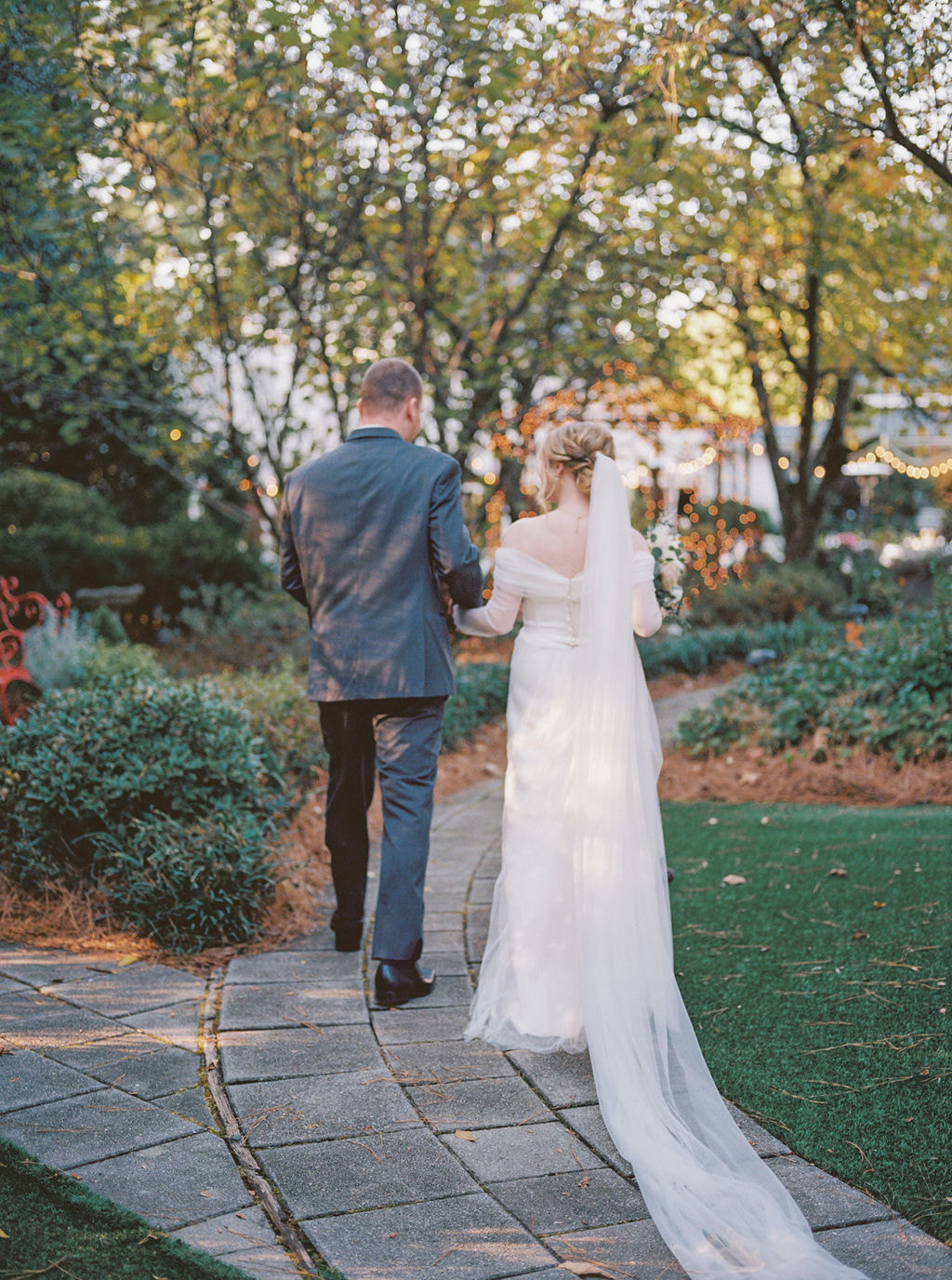 bride and groom recessing down garden venue path