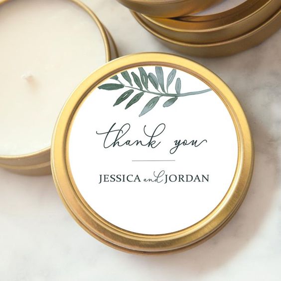 Mini individual candle favors in gold case with custom label that says 'Thank You' from Jessica and Jordan