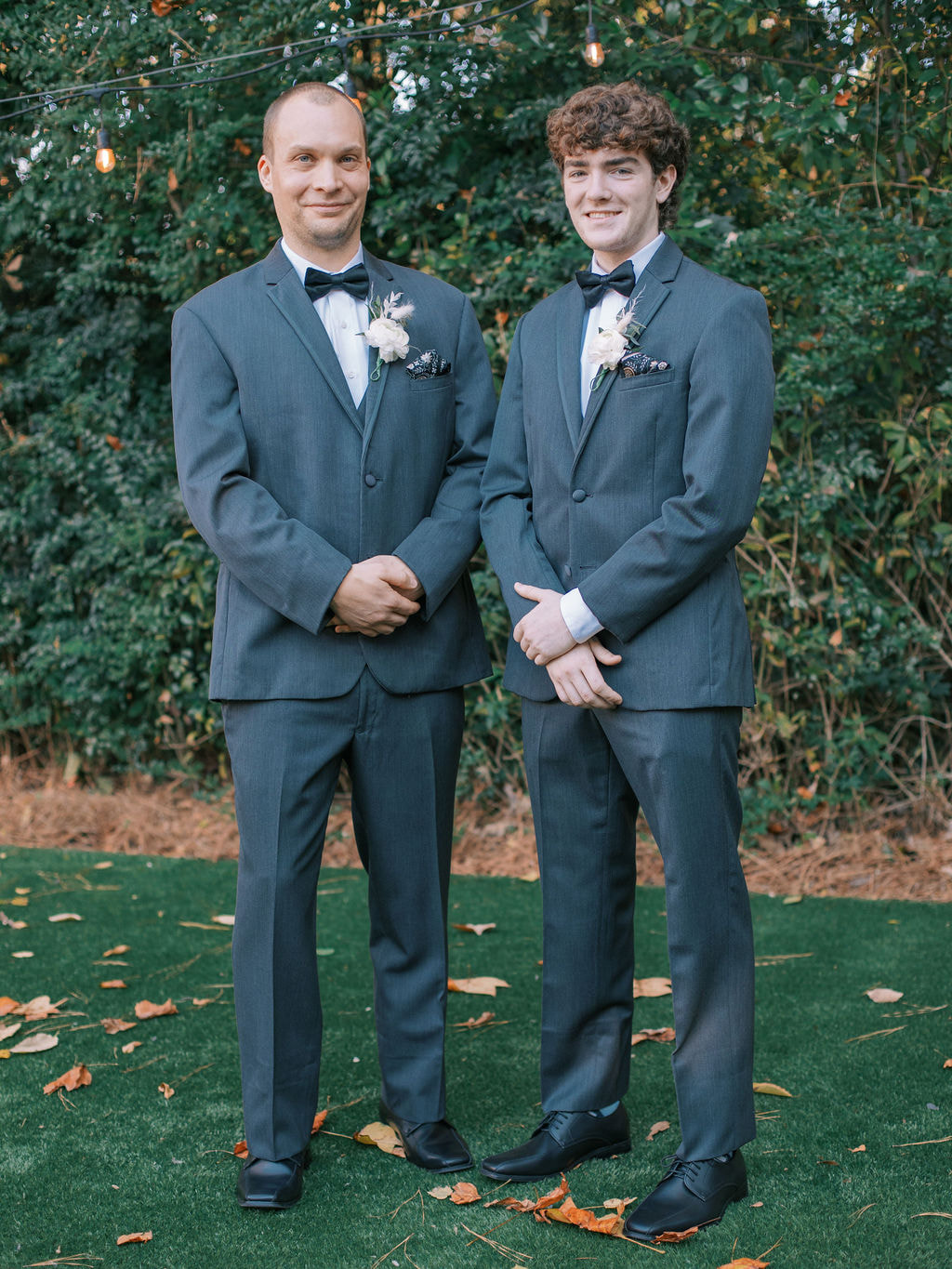 groom and groomsman in matching charcoal suits