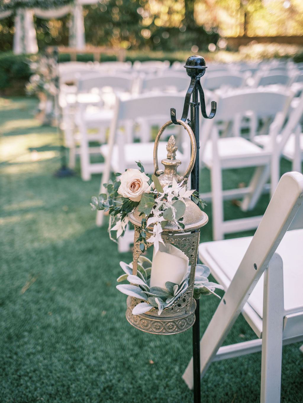 hanging gold lantern with greenery and florals