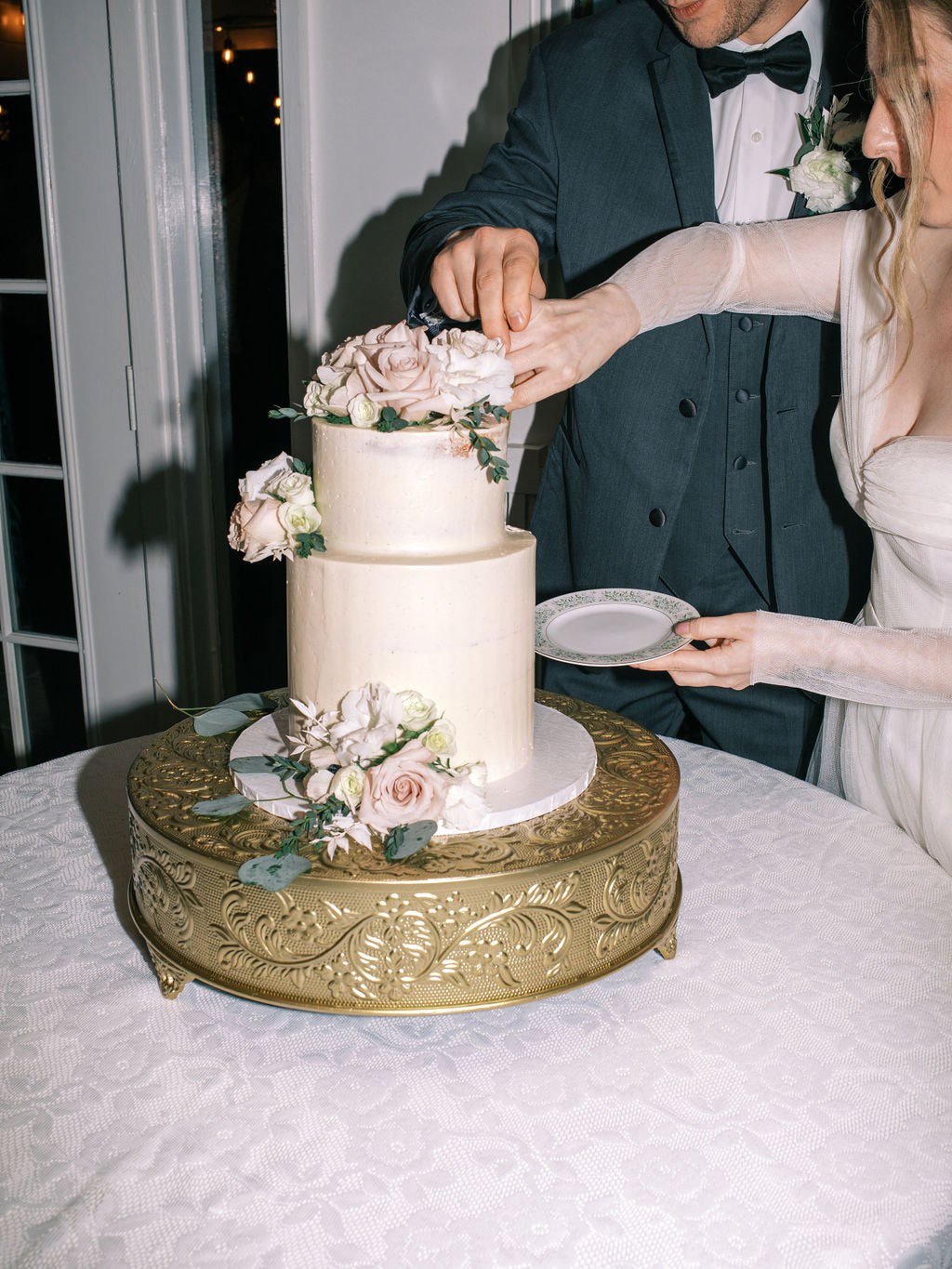 film photo of bride and groom cutting wedding cake