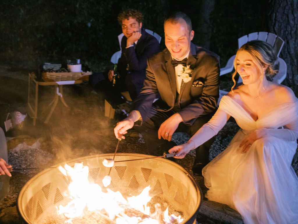 bride and groom roasting marshmallows