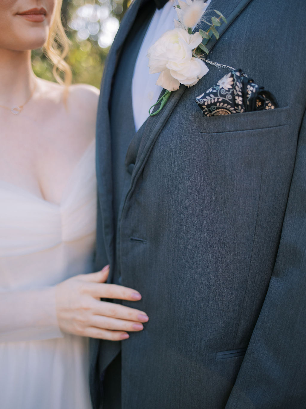 close-up photo of couple showing off groom's boutonniere