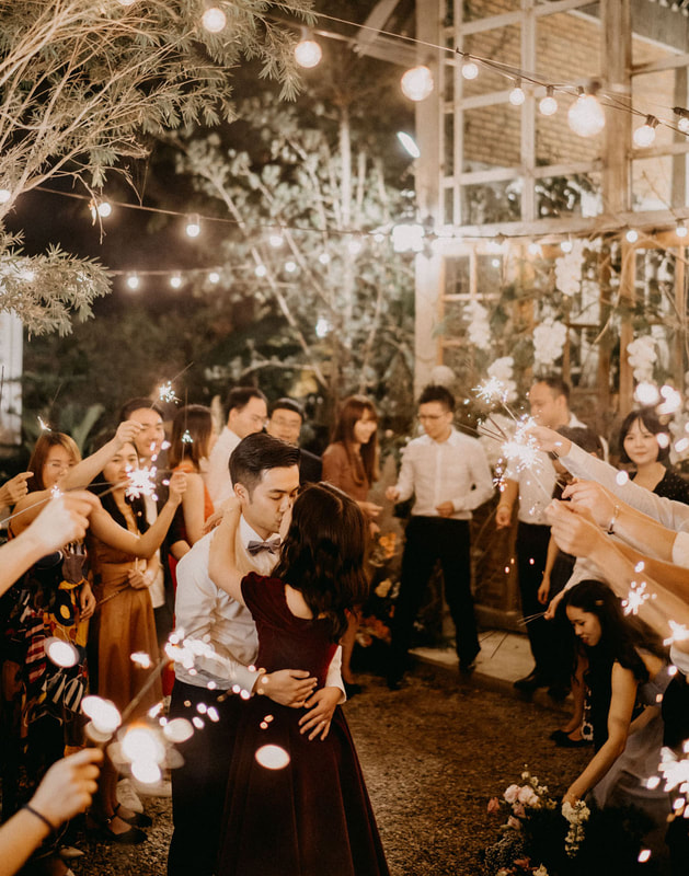 couple's first dance under sparklers at greenhouse venue