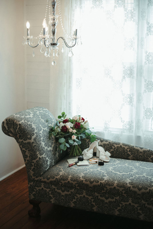 bride's bouquet and accessories on blue chaise lounge