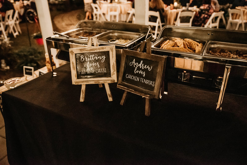 mini chalkboard signs with couple's favorite foods for reception dinner