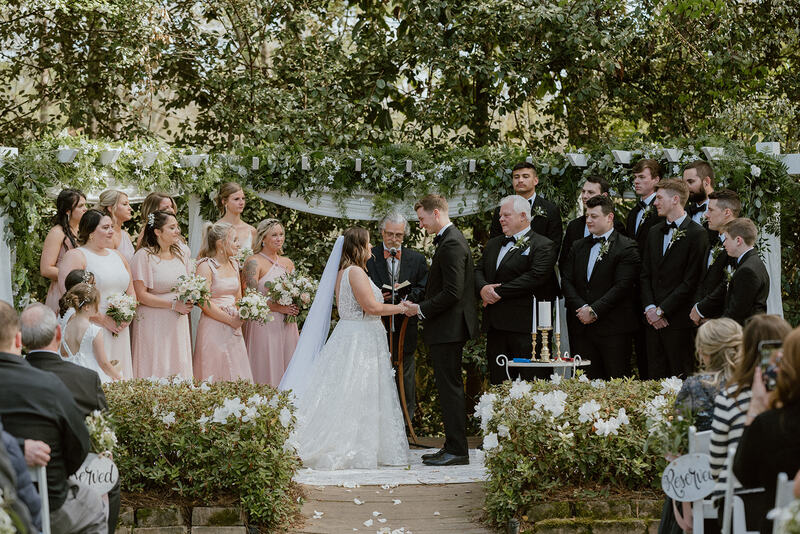 spring garden wedding ceremony with greenery and white florals