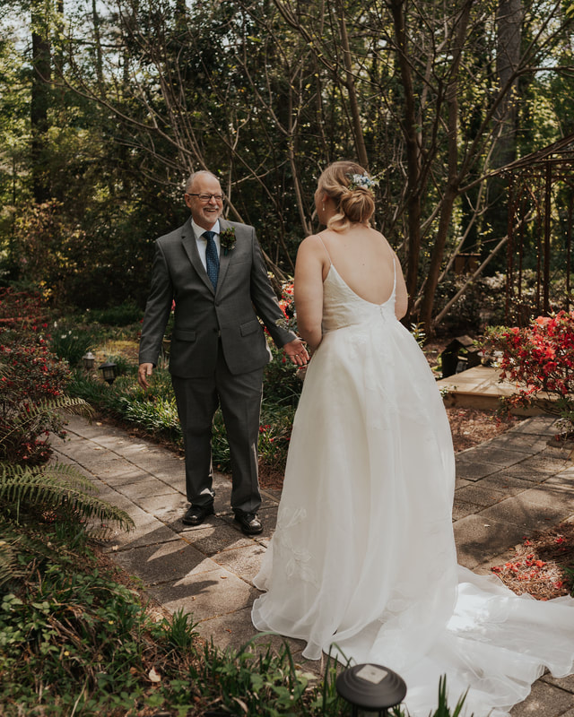 first look with father along garden venue path