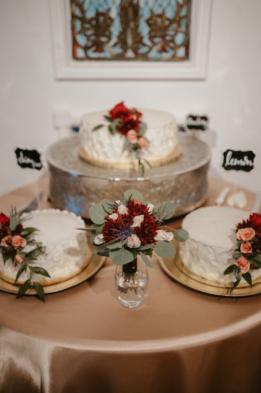 3 one-tiered cakes decorated with flowers and white frosting