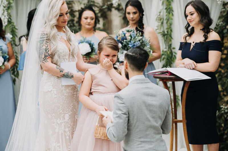 groom sharing vows with stepdaughter at garden ceremony