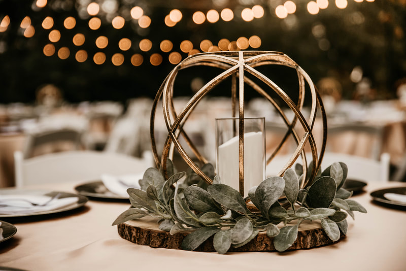 gold geometric centerpiece with led candle and lambs ear greenery
