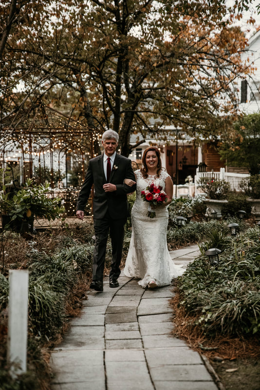 bride walks down aisle of Four Oaks' garden and ceremony area