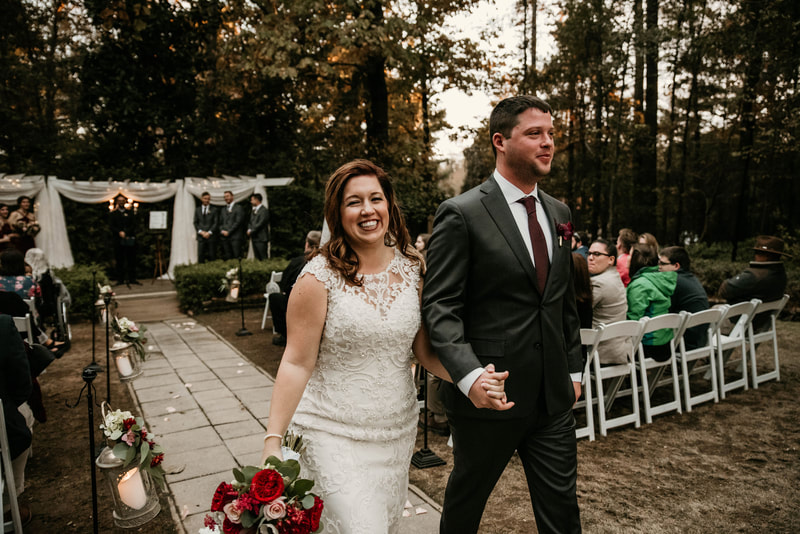 bride and groom leaving simple outdoor ceremony area during recessional