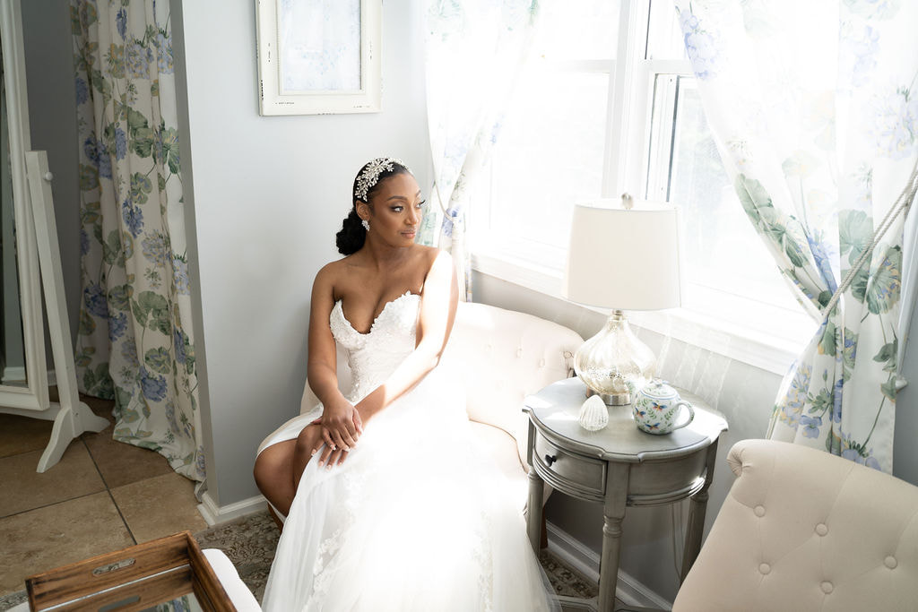 bride in strapless gown posing in neutral farmhouse bridal suite