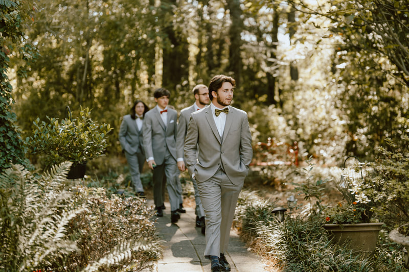 groomsmen walking down garden aisle