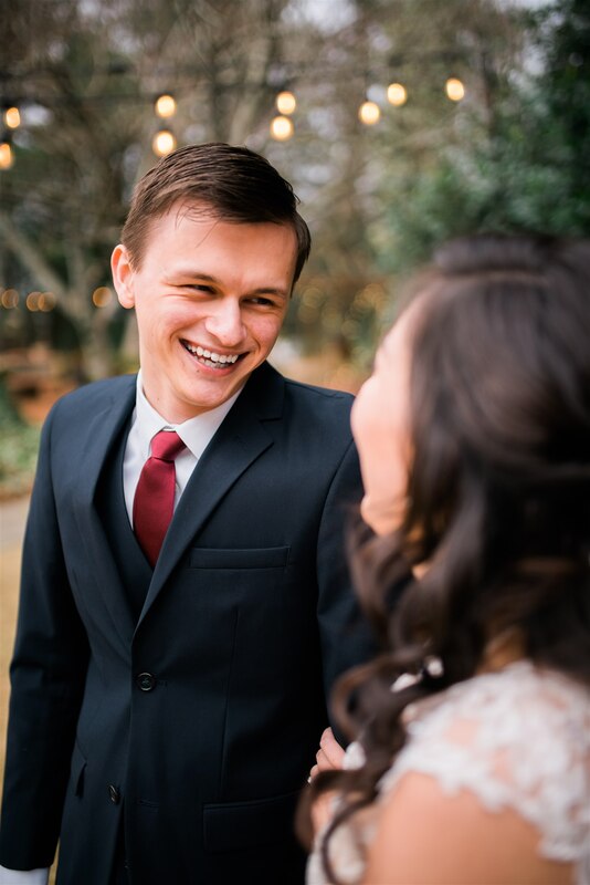 groom laughing and smiling at bride