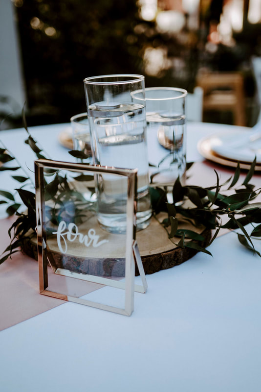 centerpiece with floating candles on wood slice with champagne details