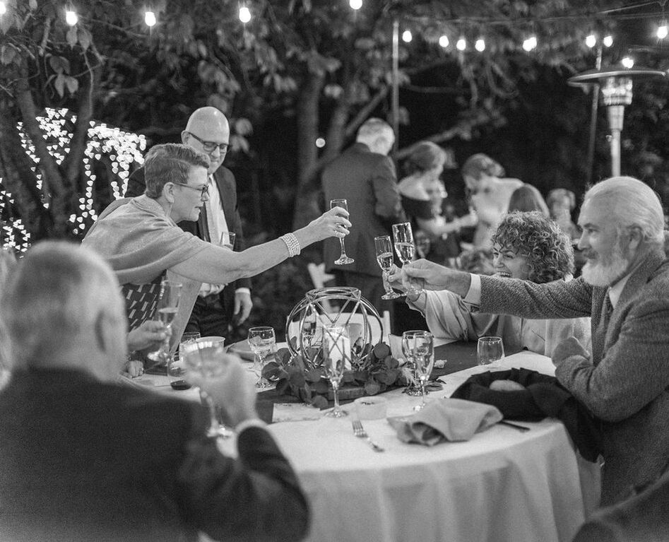 black and white photo of guests toasting champagne