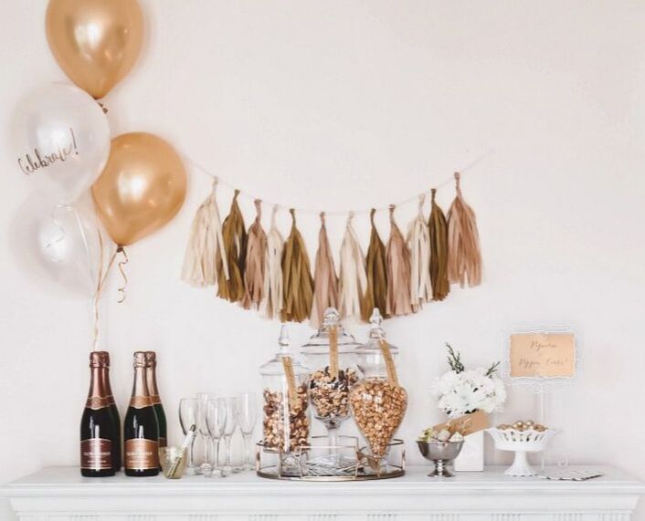 champagne and popcorn party setup with champagne and gold decorations
