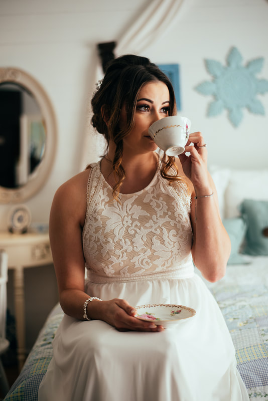 bride sipping tea from china tea cup