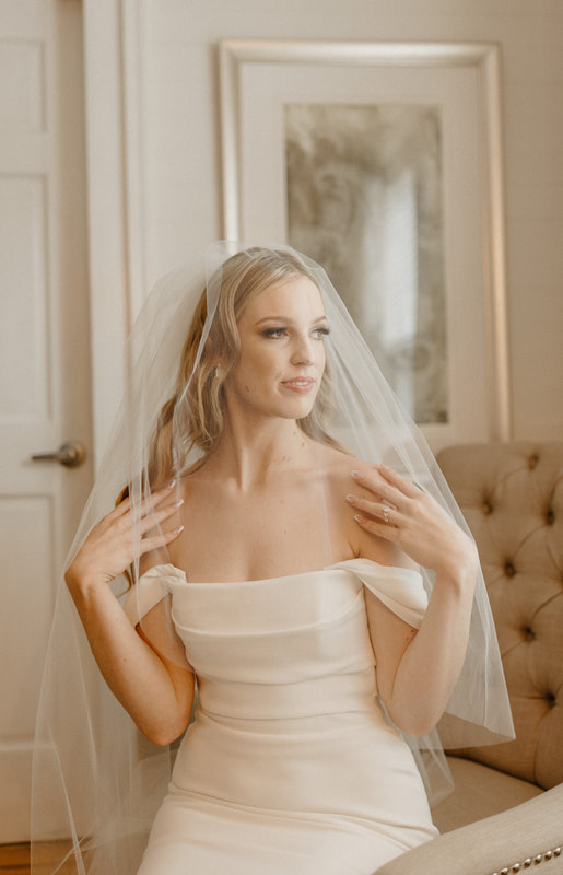 bride in strapless dress posing in farmhouse bridal suite