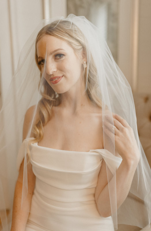 bride in strapless dress with veil over face