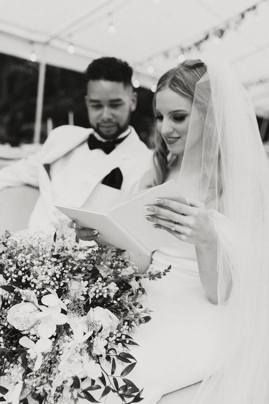 black and white photo of bride reading groom's vows