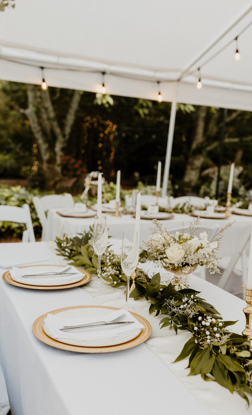 reception tables with gold decor and greenery