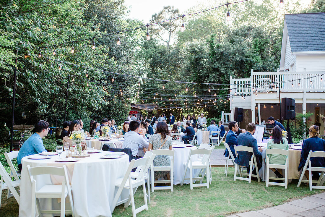 wedding guests eating at outdoor garden reception venue