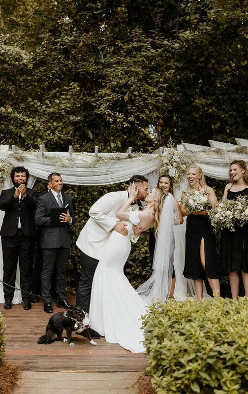 groom dips bride for kiss at altar