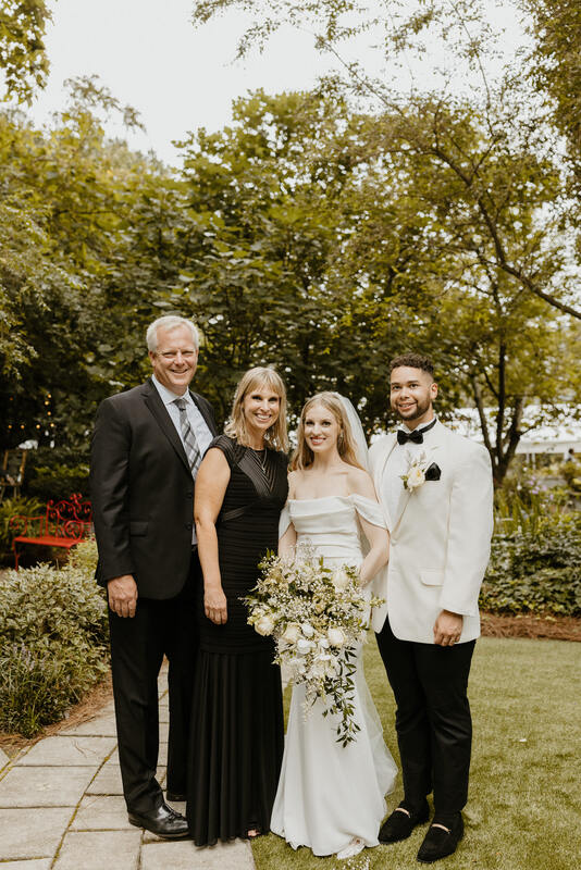 newlyweds with bride's parents