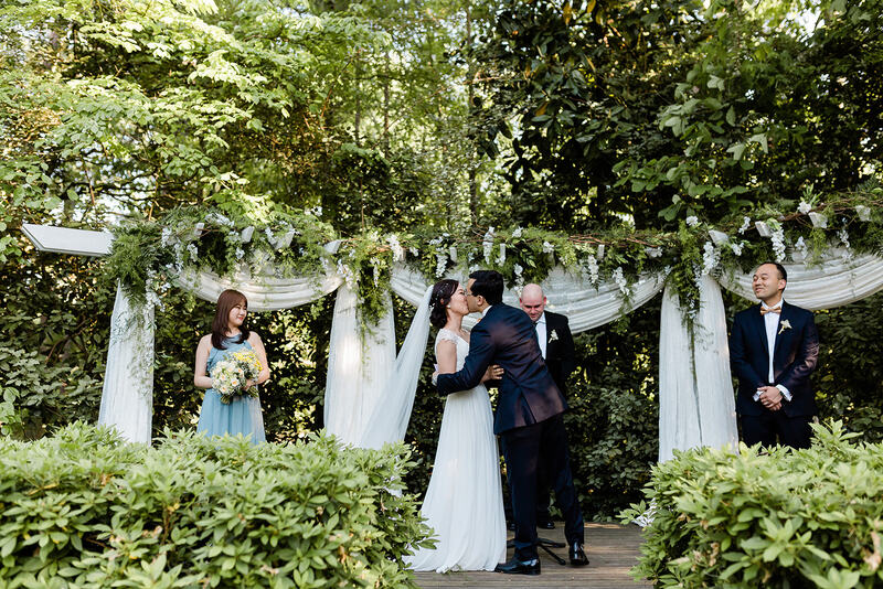 asian couple's first kiss at springtime wedding altar