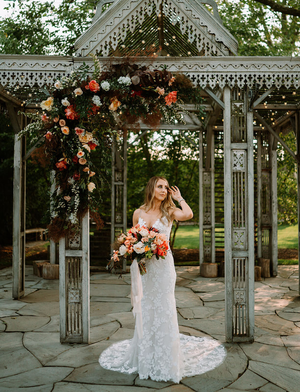 vintage gazebo decorated with greenery and flowers