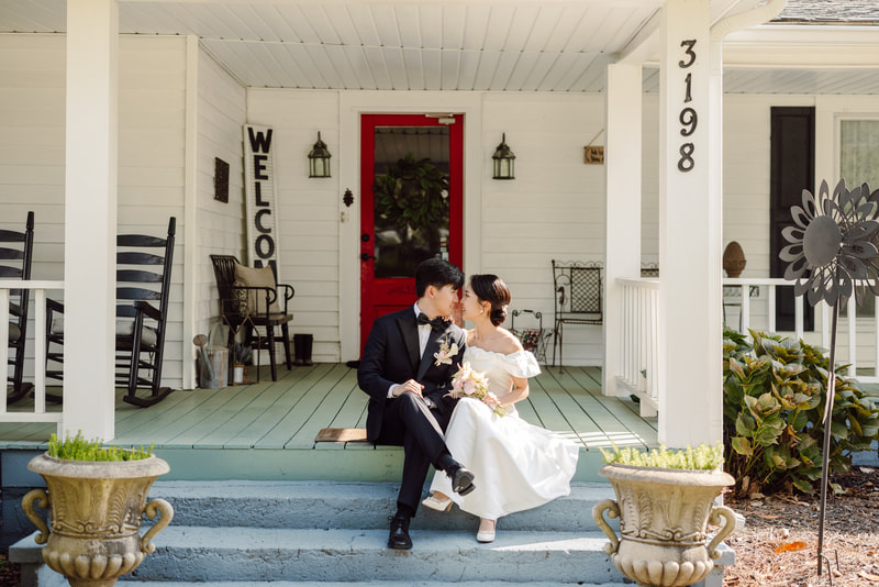 korean bride and groom sitting on farmhouse front porch steps