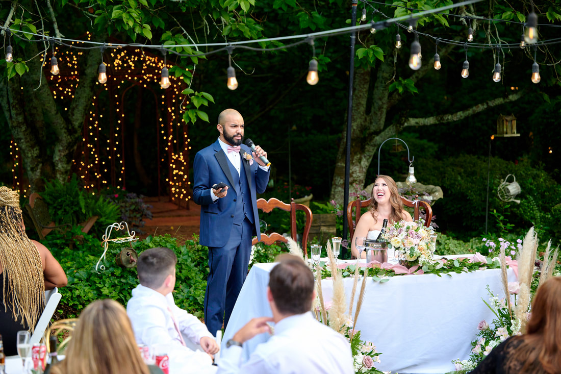 groom giving speech at garden wedding