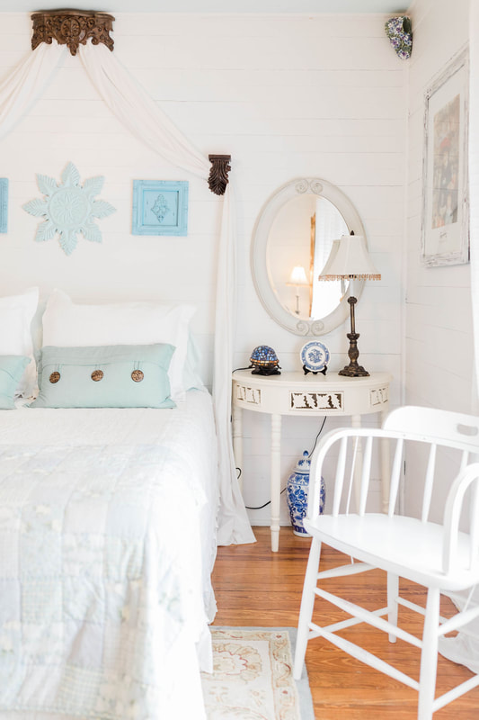 white and light blue farmhouse bedroom bridal suite