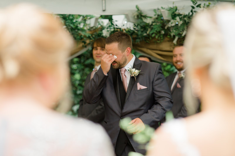 groom crying as bride walks down aisle