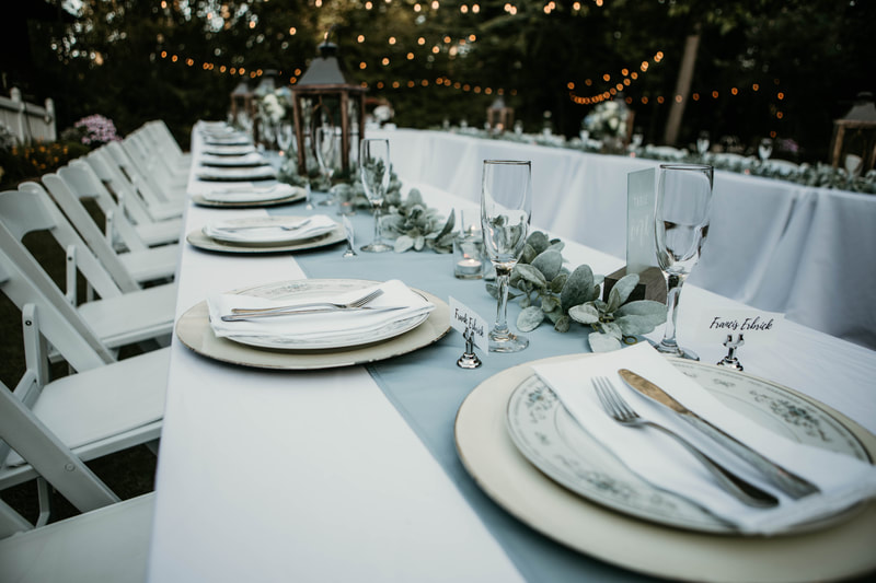 white and dusty blue reception tablescape on rectangle tables