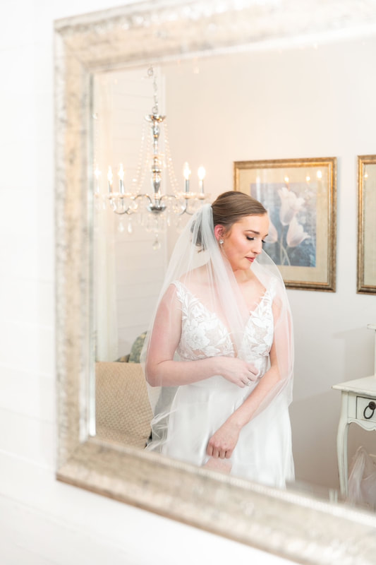 bride posing in farmhouse mirror