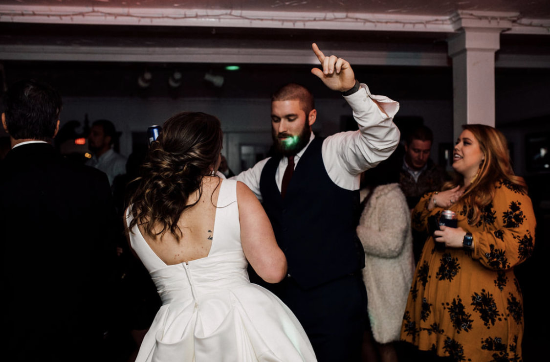 bride and groom dancing in carriage house to DJ music