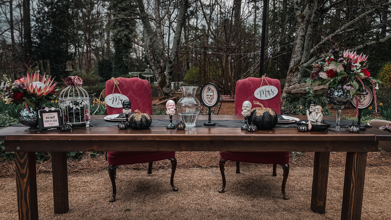 moody Halloween head table with black and burgundy details