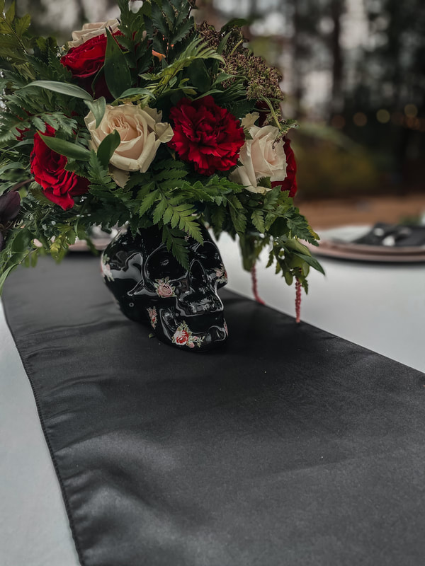 black skull vase centerpiece with flowers