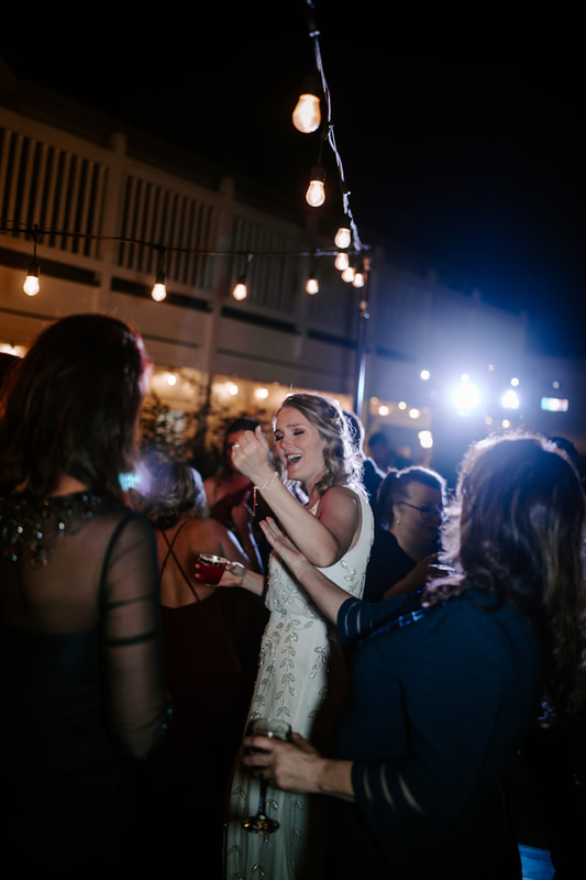 bride dancing on outdoor dance floor with wedding guests