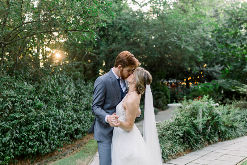 bride and groom kissing in outdoor, intimate wedding venue