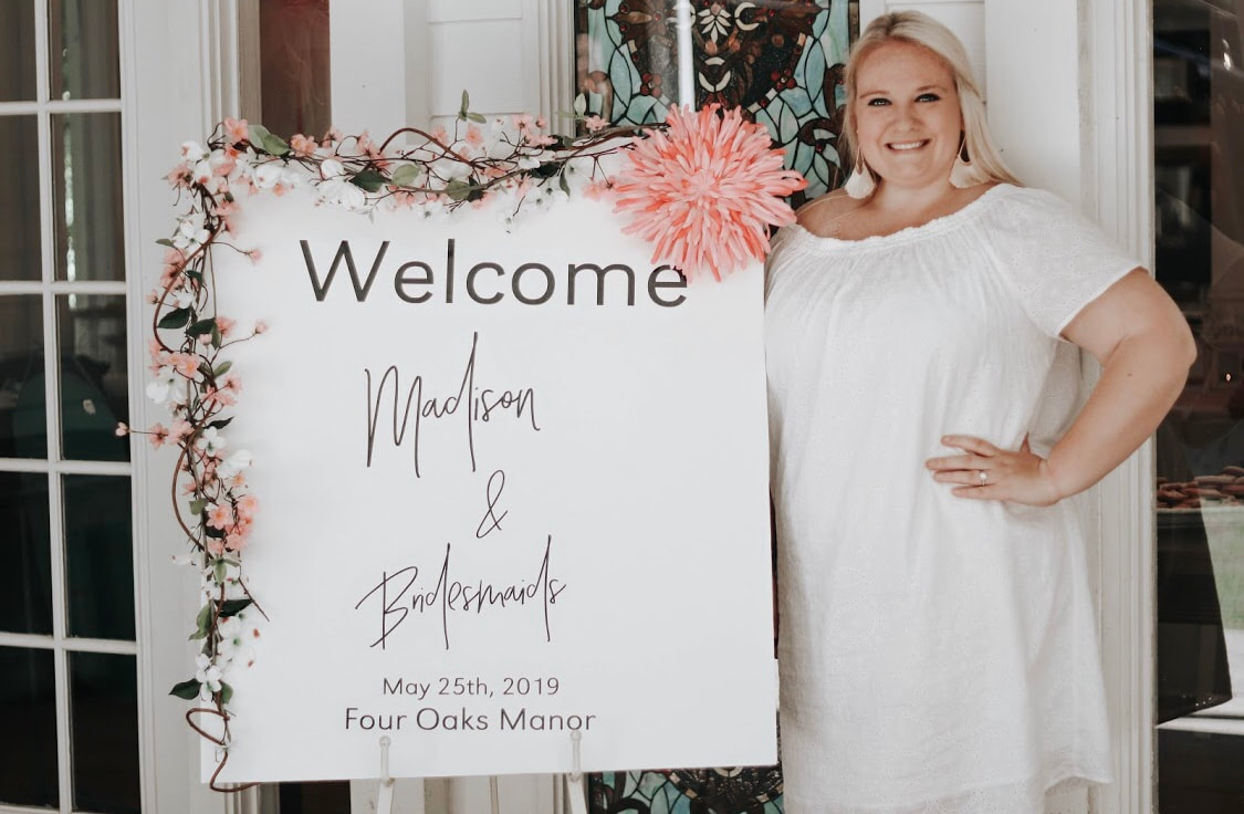 Bride at bridal luncheon with welcome sign
