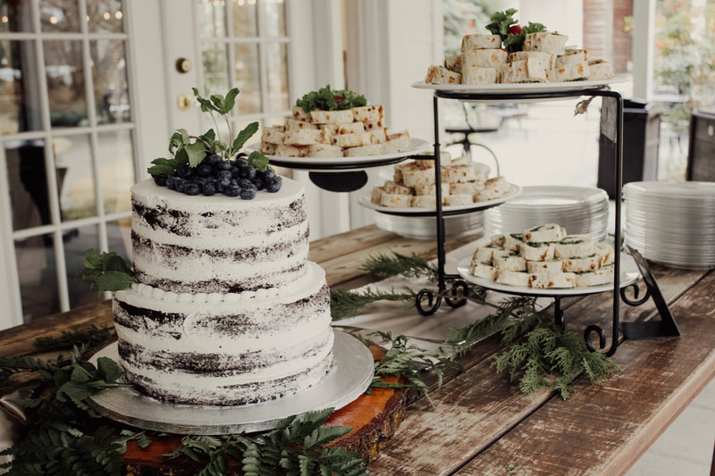 Naked cake with blueberries and pinwheel sandwiches for baby shower